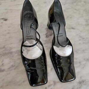This is a pair of black patent leather square-toe high heels.